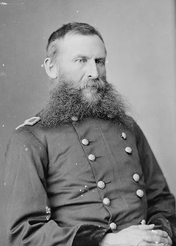 A photographic portrait of General George Crook, seated, wearing a military coat. Photo is in the public domain.