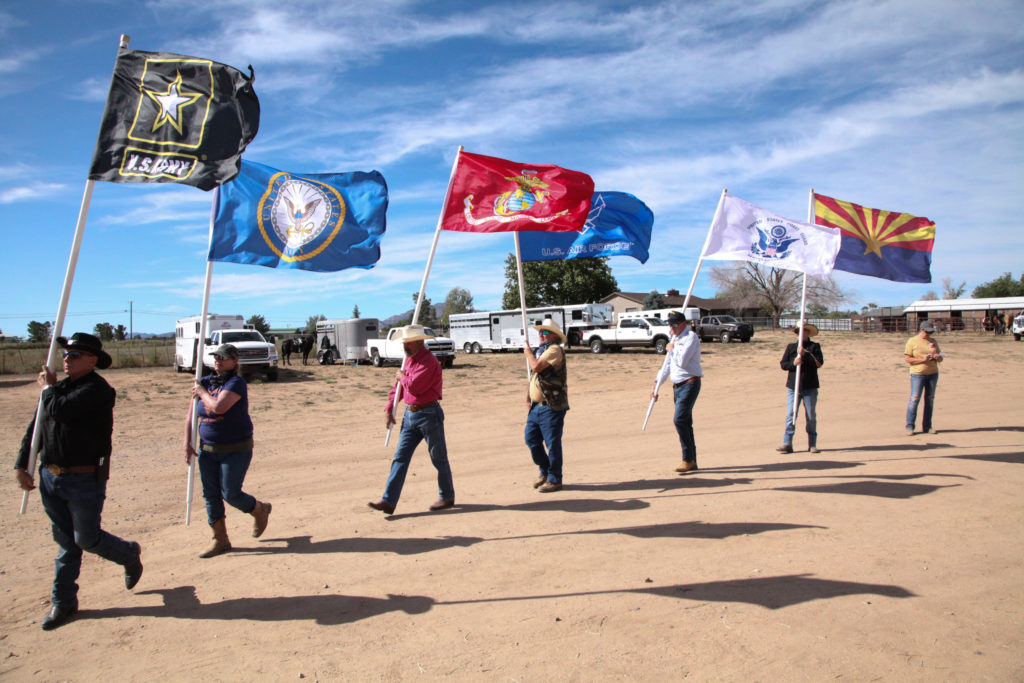 This is a photo of six military flags being paraded at the Horses with Hearts event in Chino Valley.