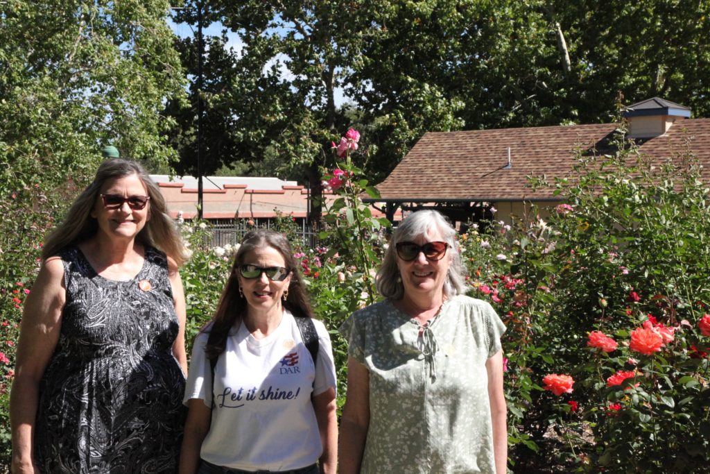 This photo shows the chapter regent and registrar giving a tour of the Sharlot Hall rose garden to the Arizona State Society DAR Regent.