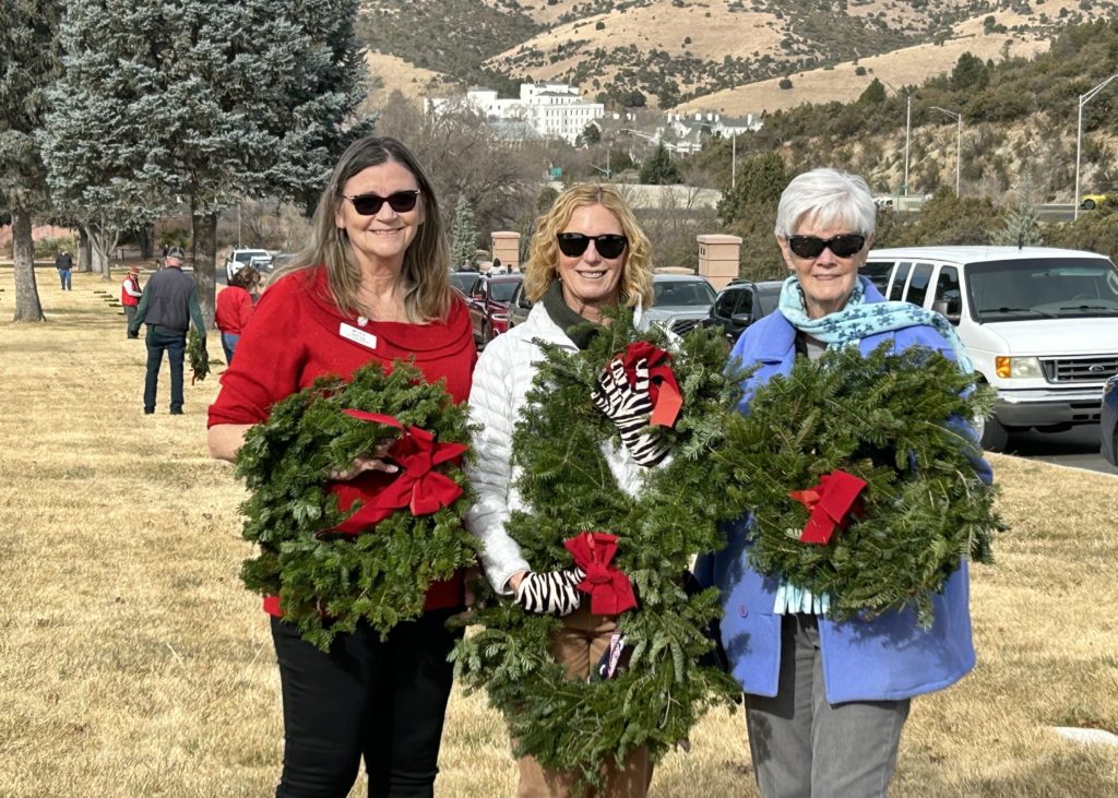 This photo shows three chapter members delivering Christmas wreaths to veterans' graves at Prescott National Cemetery in December.